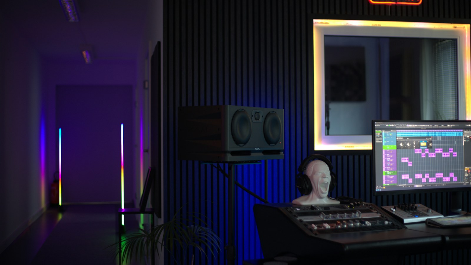 A radio imaging production room with a DAW session open on screen, studio monitors and a window into the voice booth, where seasonal radio imaging gets cut